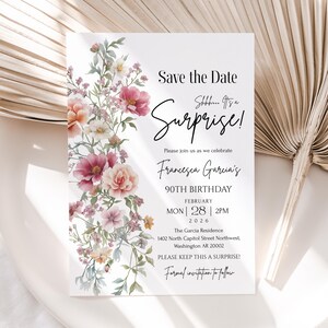 May include: A white invitation card with floral watercolor design. The text reads "Save the Date" and "Surprise!" announcing Francesca Garcia's 90th birthday on February 28, 2026, at 2 PM. The card includes the address and a request to keep it a surprise.