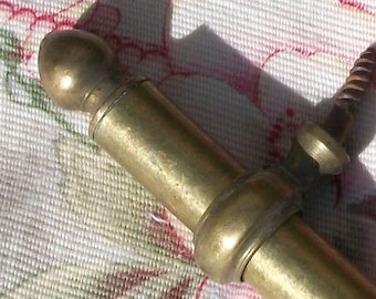 May include: A brass curtain rod finial with a rounded top and a smooth, polished finish.