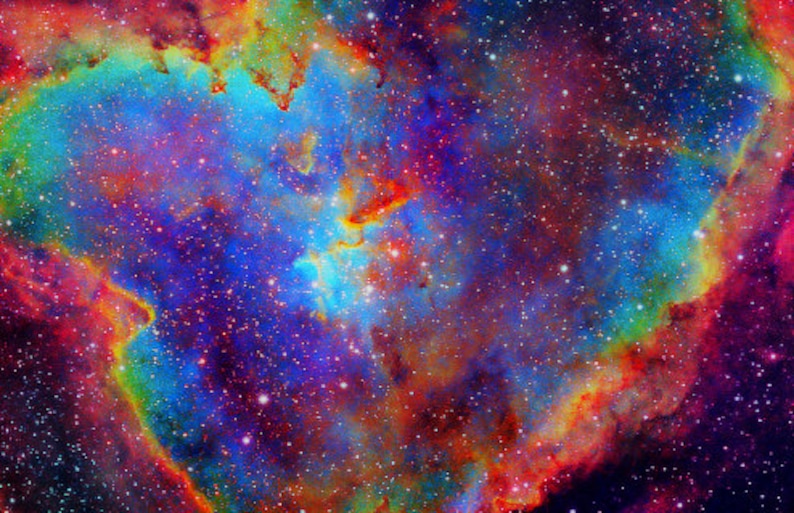 May include: A vibrant nebula with swirling colors of red, orange, yellow, green, blue, and purple. The nebula is filled with countless stars, creating a dazzling display of cosmic beauty.