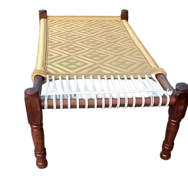 May include: A handcrafted wooden bed with a woven, diamond-patterned surface. The bed frame is dark brown, with rounded legs and a light tan woven top. The bed is designed for comfort and relaxation.