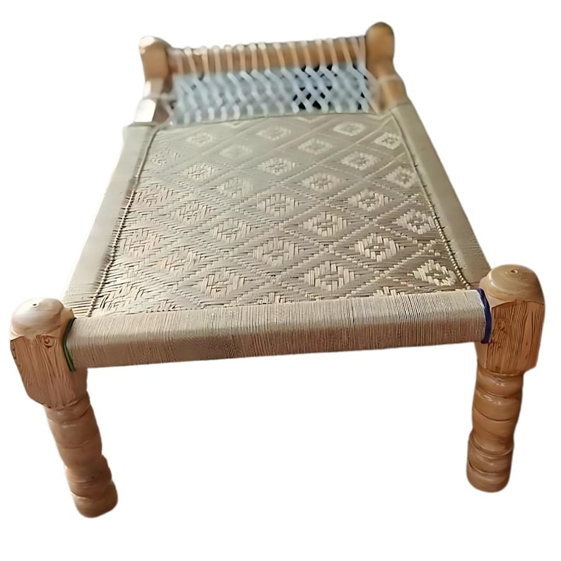 May include: A small, light-colored wooden bed frame with woven rope detailing. The bed features a woven surface and decorative wooden legs. The headboard and footboard are made of wood. The bed is designed for a small space.