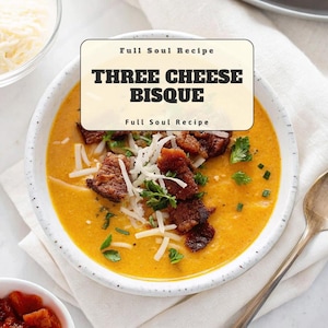 May include: A bowl of Three Cheese Bisque soup with croutons and shredded cheese. The soup is a vibrant orange color, garnished with fresh herbs. The text "Full Soul Recipe" and "THREE CHEESE BISQUE" are displayed on the image.