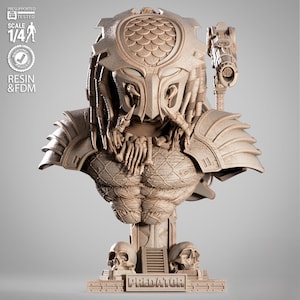 May include: A detailed bust of the Predator, a science fiction character, in a neutral color. The bust features intricate details of the Predator's mask, dreadlocks, and armor. The base includes two skulls and the word "PREDATOR".