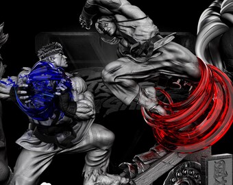 May include: A promotional image for Street Fighter featuring three character busts and a central action scene. The central figures are engaged in combat, with dynamic red energy effects. The image is primarily grayscale with blue and red accents.