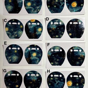 May include: A collection of eight pairs of stickers, each featuring a whimsical design. The stickers showcase a dark blue and yellow swirling pattern reminiscent of Van Gogh's "Starry Night" painting, with a white face and two white dots.