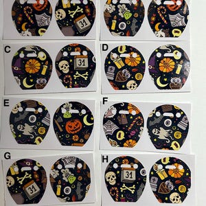 May include: A collection of Halloween-themed stickers with various designs. Each sticker features a black background with orange, purple, and white illustrations of pumpkins, ghosts, skulls, and candy. Some stickers include the number "31".