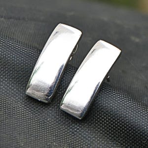 Pair of polished sterling silver rectangular stud earrings front view