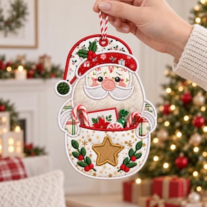 May include: A fabric Christmas ornament shaped like Santa Claus, featuring a red hat with holly, a white beard, and a pocket filled with candy canes and a poinsettia card. The pocket is decorated with a gold star and green holly sprigs.