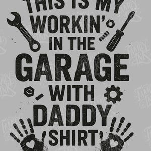 May include: Gray t-shirt with the text "THIS IS MY WORKIN' IN THE GARAGE WITH DADDY SHIRT" in a distressed black font. The design includes wrench, screwdriver, gear, and handprint graphics.