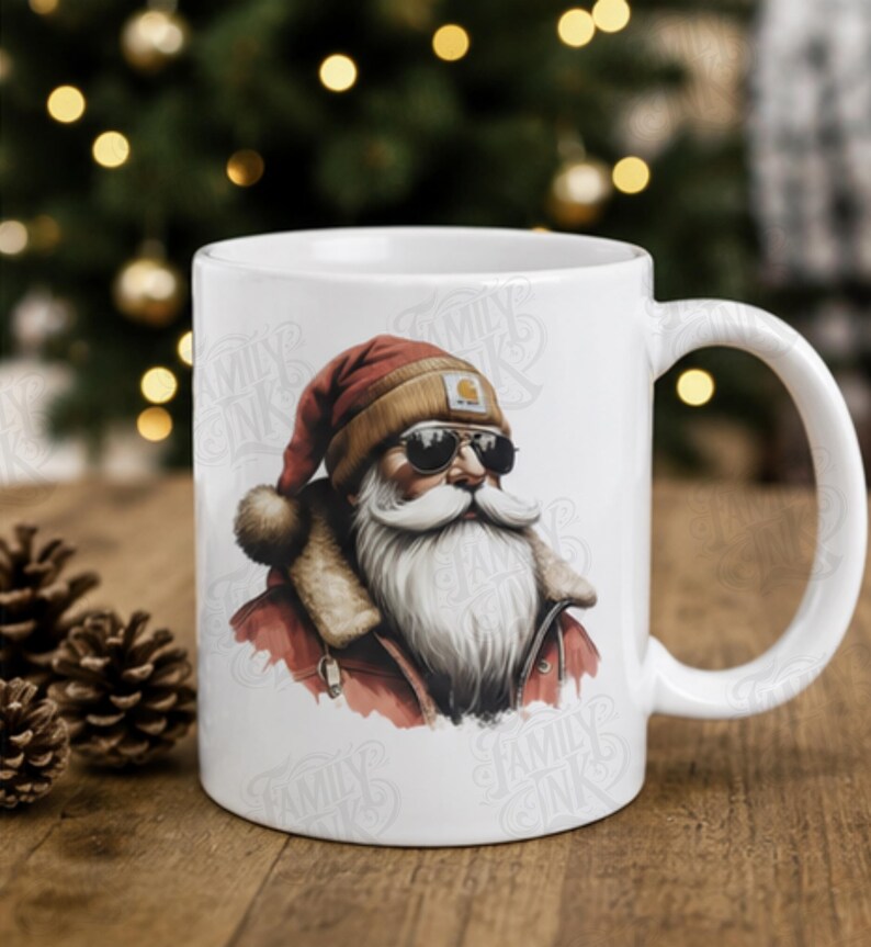 May include: A white ceramic mug featuring a graphic illustration of Santa Claus wearing a tan beanie, dark sunglasses, and a red jacket with a fur-lined collar. The design includes a watermark text that reads Family Ink across the mug surface.