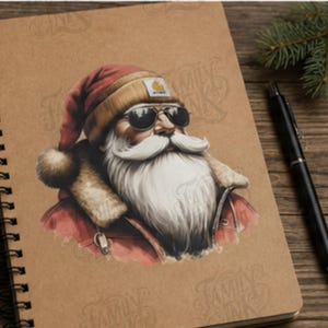 May include: A spiral-bound notebook with a tan cover featuring a graphic illustration of Santa Claus wearing a red hat, a tan beanie, and black sunglasses. The illustration shows Santa with a long white beard and a red jacket with fur trim.