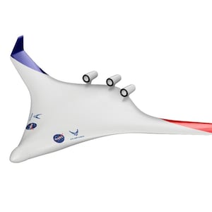 May include: A white aircraft model with a distinctive wing shape, with blue and red detailing on the wingtips. The model has three engine nacelles and logos for NASA and the U.S. Air Force. The aircraft is set against a white background.