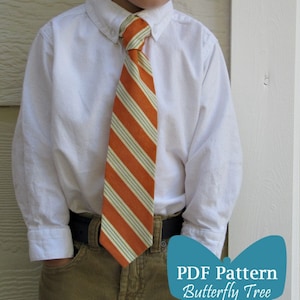 May include: A young boy wearing a white button-down shirt with an orange and white striped tie. He is wearing brown corduroy pants and a brown belt. The image includes the text "PDF Pattern Butterfly Tree".