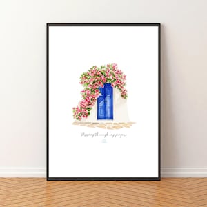 May include: A framed art print featuring a blue door adorned with pink flowers. The artwork has the text "Stepping through my fingers" at the bottom. The print is set against a white background and framed in black.