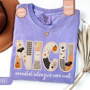 May include: A violet short-sleeved t-shirt featuring the letters NICU in a patchwork design with Halloween motifs including pumpkins, ghosts, bats, and spiderwebs. The text neonatal intensive care unit is printed in white below the letters.