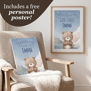 May include: A personalized children's book and framed poster with a teddy bear illustration. The book and poster feature the name "EMMA" and the phrases "Prayers for EMMA" and "God Loves EMMA" in a blue and white color scheme. The items are displayed on a chair with a fluffy white blanket.