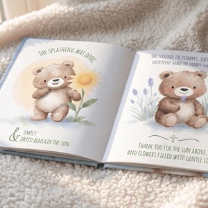 May include: Open book with watercolor illustrations. One page shows a brown teddy bear with a sunflower, text reads "The Splashing Was Done" and "Emily Dried Beneath the Sun." The other page shows a bear with lavender, text reads "She sniffed the flowers, soft..."