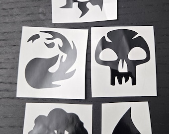 May include: A collection of five black and white vinyl stickers featuring stylized symbols. Designs include a sunburst, a flame, a skull, a tree, and a water droplet. These stickers are likely for a trading card game or similar hobby.