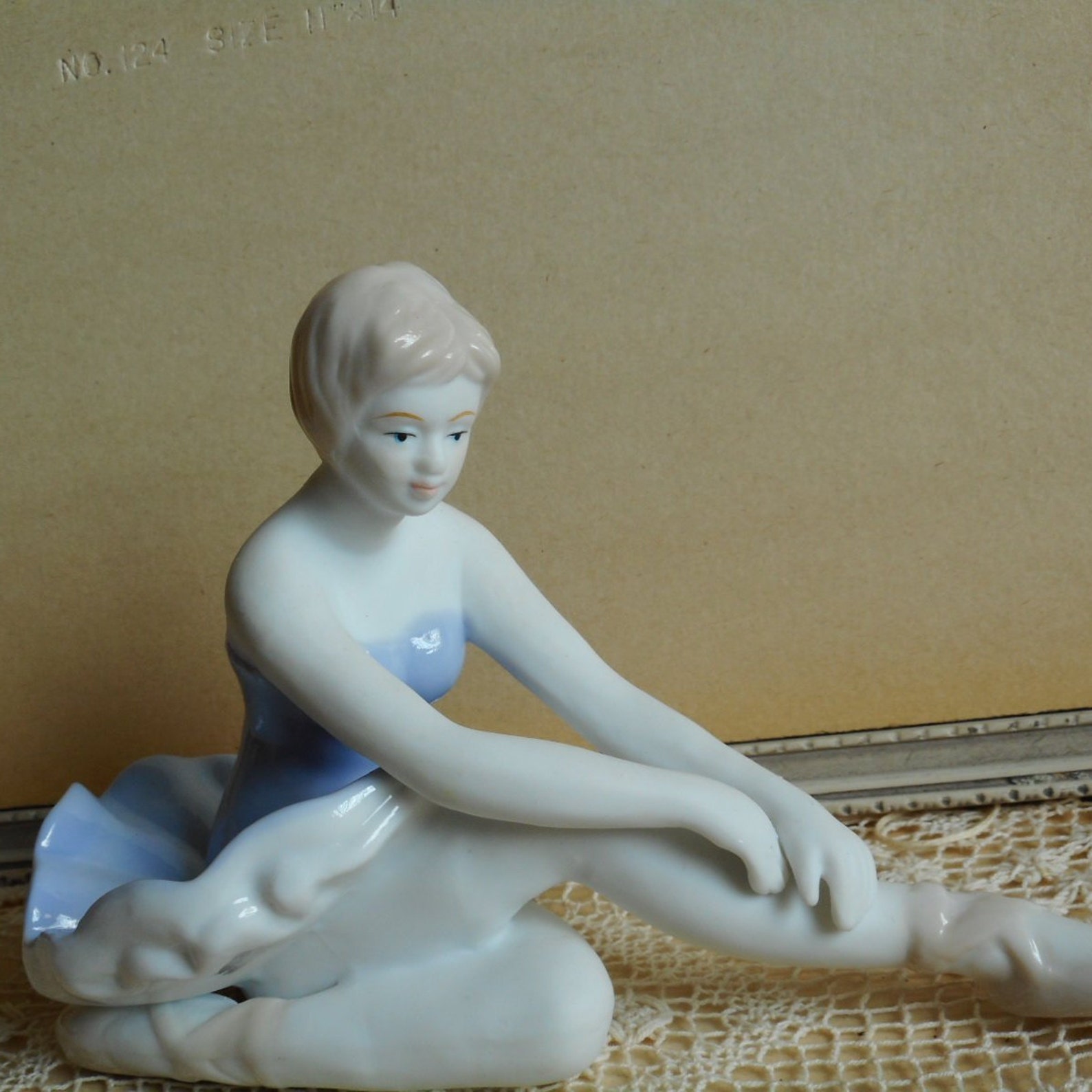 vintage fine porcelain ballerina. very soft blue and white dress. light beige hair and shoes. ballet dancer.