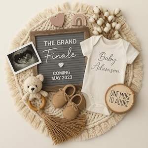 May include: A baby announcement featuring a gray letter board with the text "THE GRAND FINALE COMING MAY 2023." The scene includes a baby onesie, ultrasound scan, baby shoes, a wooden toy, and a wooden disc that says "ONE MORE TO ADORE."