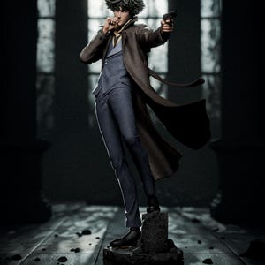 May include: A collectible figurine of a character with spiky dark hair, wearing a blue suit, a yellow shirt, and a long brown trench coat. The figure holds a small black handgun in one hand and a cigarette in the other, standing on a stone base.