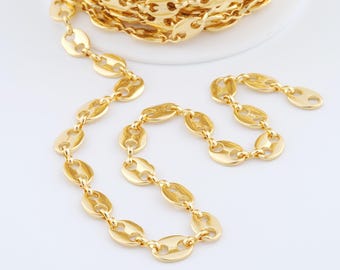 May include: A gold-colored chain with a unique bean-shaped link design. The chain is displayed in a coil and also laid out in a line, showcasing its texture and shine. The links are approximately 0.5 inches in length, suitable for jewelry making.