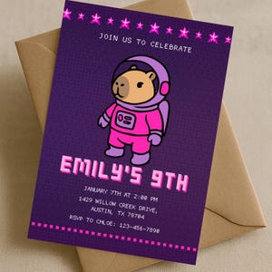 May include: A purple invitation card with a cartoon capybara astronaut. The text reads "Join us to celebrate" and "Emily's 9th". Additional text includes the date, time, address, and RSVP information. The card is set against a tan envelope.