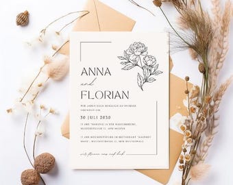 Puede incluir: Una invitación de boda crema con los nombres "ANNA" y "FLORIAN" en texto negro, junto con ilustraciones florales. La invitación está sobre un sobre marrón, con flores secas y elementos decorativos alrededor.