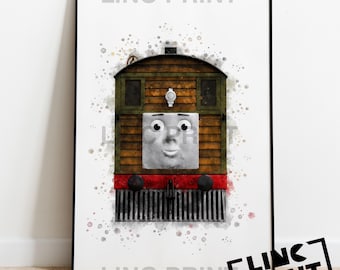 Puede incluir: Impresión enmarcada con una ilustración de acuarela de Toby, la locomotora de tranvía de Thomas & Friends. El tren se representa con una cara sonriente, cuerpo marrón, detalles rojos y una parrilla negra. La impresión está sobre un fondo blanco con salpicaduras de acuarela.