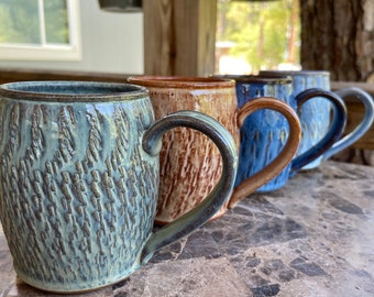 Eclectic Set of 4 handmade stoneware pottery mugs with exterior texture and four colors! Sold as set. Actual items pictured