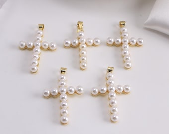 May include: Five gold-tone cross pendants, each adorned with white faux pearls. The crosses have a classic design, with a loop at the top for hanging. The pearls are evenly spaced, creating a delicate and elegant look.