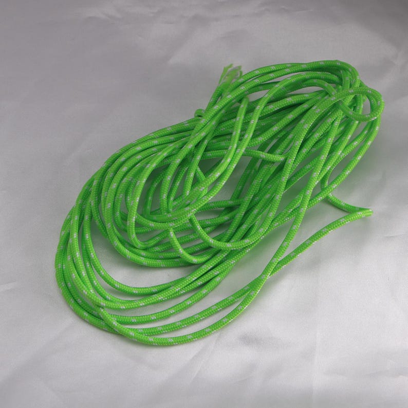 May include: A coiled length of bright green rope with a white speckled pattern. The rope is tightly wound, suggesting it is new and unused. The vibrant color and texture are clearly visible against a neutral background.