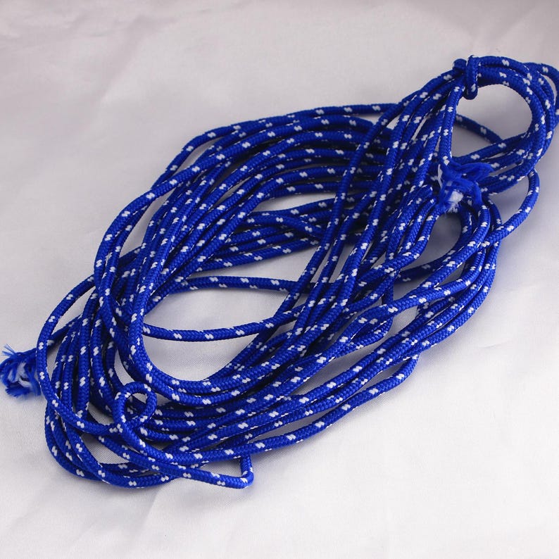May include: A length of blue rope with a white dotted pattern. The rope is coiled and knotted at one end. The rope is made of a durable material and is suitable for various uses.