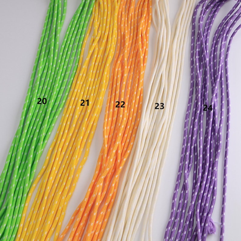May include: A collection of colorful cords in shades of green, yellow, orange, cream, and purple. The cords are numbered 20 through 24. The yellow, orange, and purple cords have a white dotted pattern.