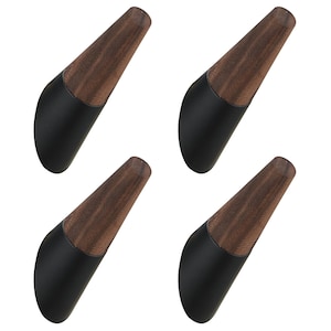 May include: Four bottle stoppers with a two-tone design. The top portion is a dark brown wood grain, and the bottom is black. The stoppers have a curved, ergonomic shape.