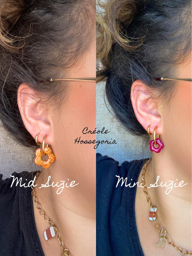 May include: Two close-up shots of earrings. The left earring is a gold hoop with an orange flower charm, labeled "Mid Suzie." The right earring is a gold hoop with a pink flower charm, labeled "Mini Suzie." The text "Cr&eacute;ole Hossegoria" is at the top.
