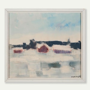 May include: An oil painting in a white frame depicts a winter landscape. Red-roofed buildings are covered in snow, set against a backdrop of dark trees and a light blue sky. The artwork has a textured, impressionistic style.