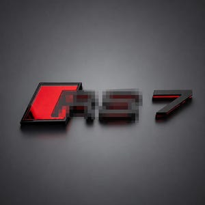 May include: A black and red emblem featuring the text RS 7. The emblem has a rectangular red background behind the letters RS, which are pixelated, followed by a separate black number 7. The design is set against a solid dark gray background.