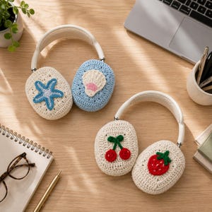 May include: Two pairs of over-ear headphones featuring removable crochet covers. One pair has a cream cover with a blue starfish and a light blue cover with a seashell. The second pair has cream covers decorated with a red cherry motif and a red strawberry.