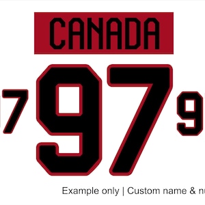 May include: A white graphic design featuring the word "CANADA" in black block letters on a red rectangle. The number "97" is displayed three times in black with red outlines. Text at the bottom reads "Example only | Custom name & number".