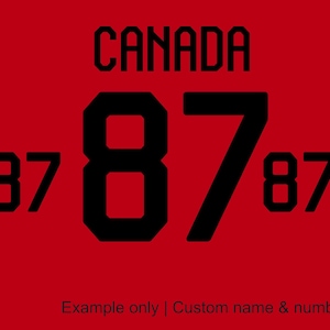 May include: Red background with the word "CANADA" in black block letters. Large black number "87" dominates the center, flanked by smaller "87"s. The text "Example only | Custom name & number" is at the bottom.