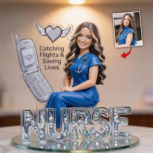 May include: A figurine of a nurse in blue scrubs, with a stethoscope, next to a cell phone graphic. The base spells "NURSE" in silver letters. The text on the graphic reads "Catching Flights & Saving Lives". The figurine sits on a glass surface.