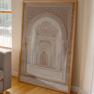 May include: A framed print of an architectural interior with a series of arched doorways receding into the distance. The print features intricate details and a neutral color palette, with a wooden frame.