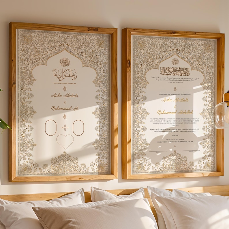 May include: Two rectangular wooden frames containing off-white wedding certificates with intricate gold floral borders. The left print features Arabic calligraphy, the names Aisha Abubakr and Muhammad Ali, and a heart icon. The right print displays text.