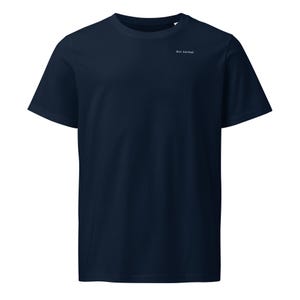 May include: A dark navy blue short-sleeved t-shirt featuring a crew neckline. The upper chest area displays the small white text "Act normal" printed in a simple, clean font. The garment is constructed with a standard fit and plain fabric.