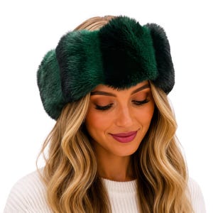 May include: A wide headband made of thick, plush faux fur featuring alternating vertical stripes of deep forest green and black. The textured accessory has a soft, voluminous appearance with a consistent pile throughout the entire band.