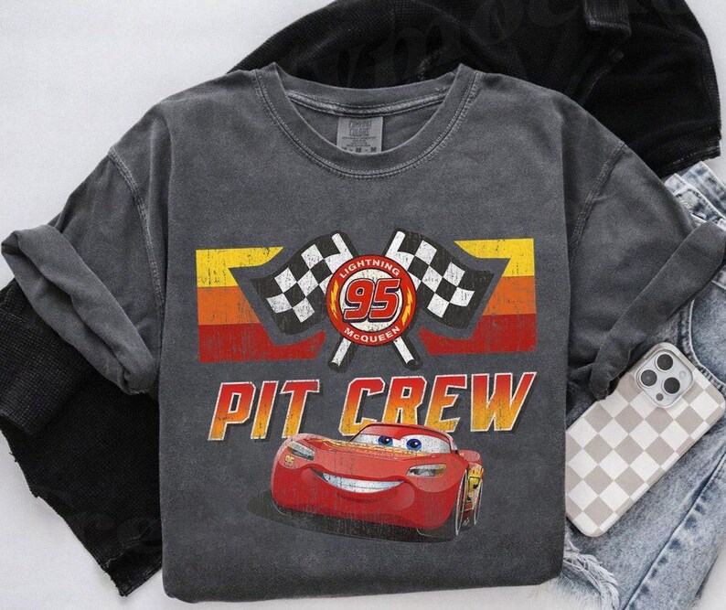 May include: A white ceramic mug with a black handle and the text "But First, Coffee" in a bold, black font. The mug is set against a neutral background, highlighting its simple design.