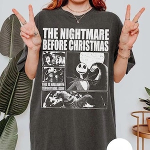 May include: A charcoal grey short-sleeve t-shirt featuring a white graphic print of The Nightmare Before Christmas. The design includes the movie title, scenes with Jack Skellington, and the text This is Halloween Everybody Make a Scene.