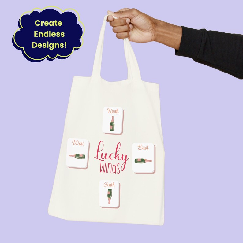 May include: Cream-colored tote bag with the text "Lucky Winds" and directional labels. The bag features illustrations of champagne bottles. The phrase "Create Endless Designs!" is in a blue cloud-shaped text box.