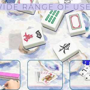 May include: White Mahjong tiles with red, green, and black symbols are scattered on a patterned surface. The image includes the text "WIDE RANGE OF USES". Additional images show playing cards, dominoes, and more Mahjong tiles.